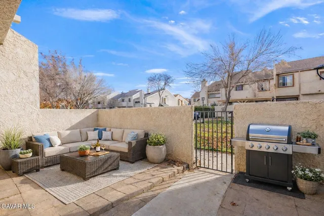 a backyard of a house with fire pit and outdoor seating