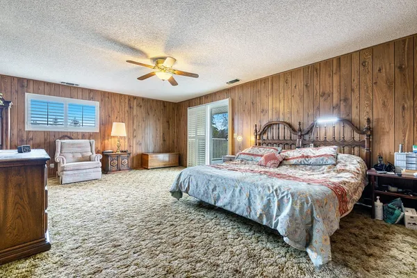 a bedroom with a bed and a couch