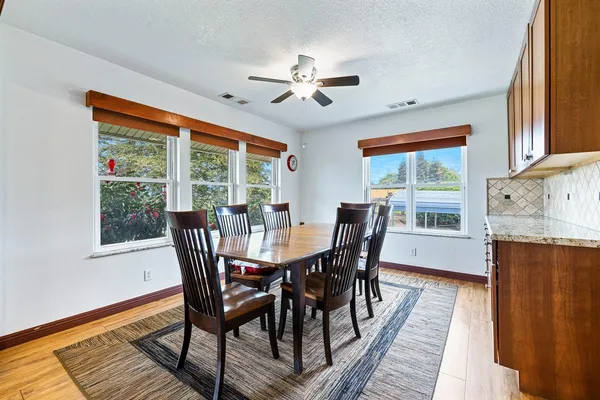 a view of a dining room with furniture window and wooden floor