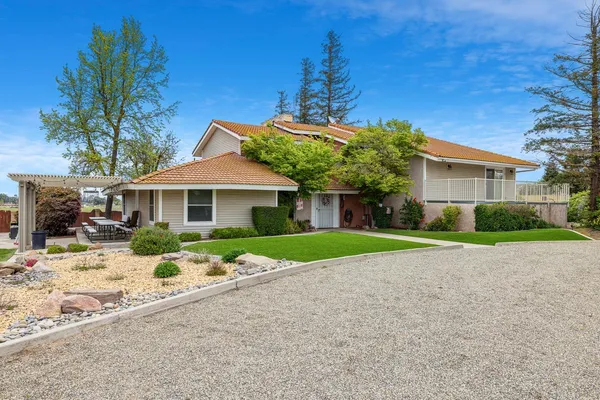 a front view of house with yard and green space