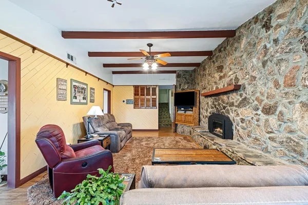 a living room with furniture and a fireplace