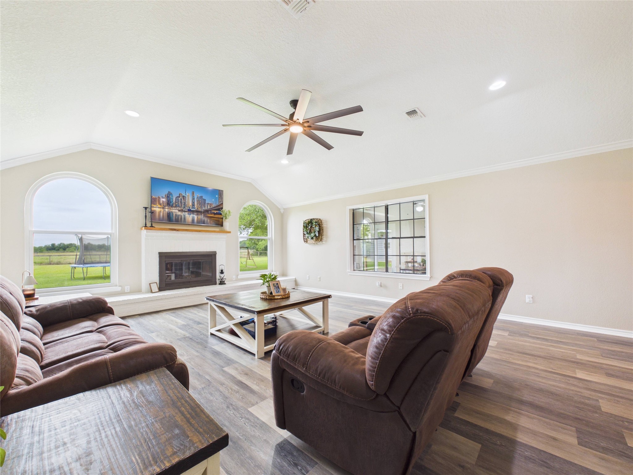 4610 Mustang Road Alvin, TX 77511 - Photo 13 of 50 Updated fixtures, crown molding, picture windows, beautiful brick fireplace and another window that allows you to keep track of activities in the adjoining sunroom/play room.