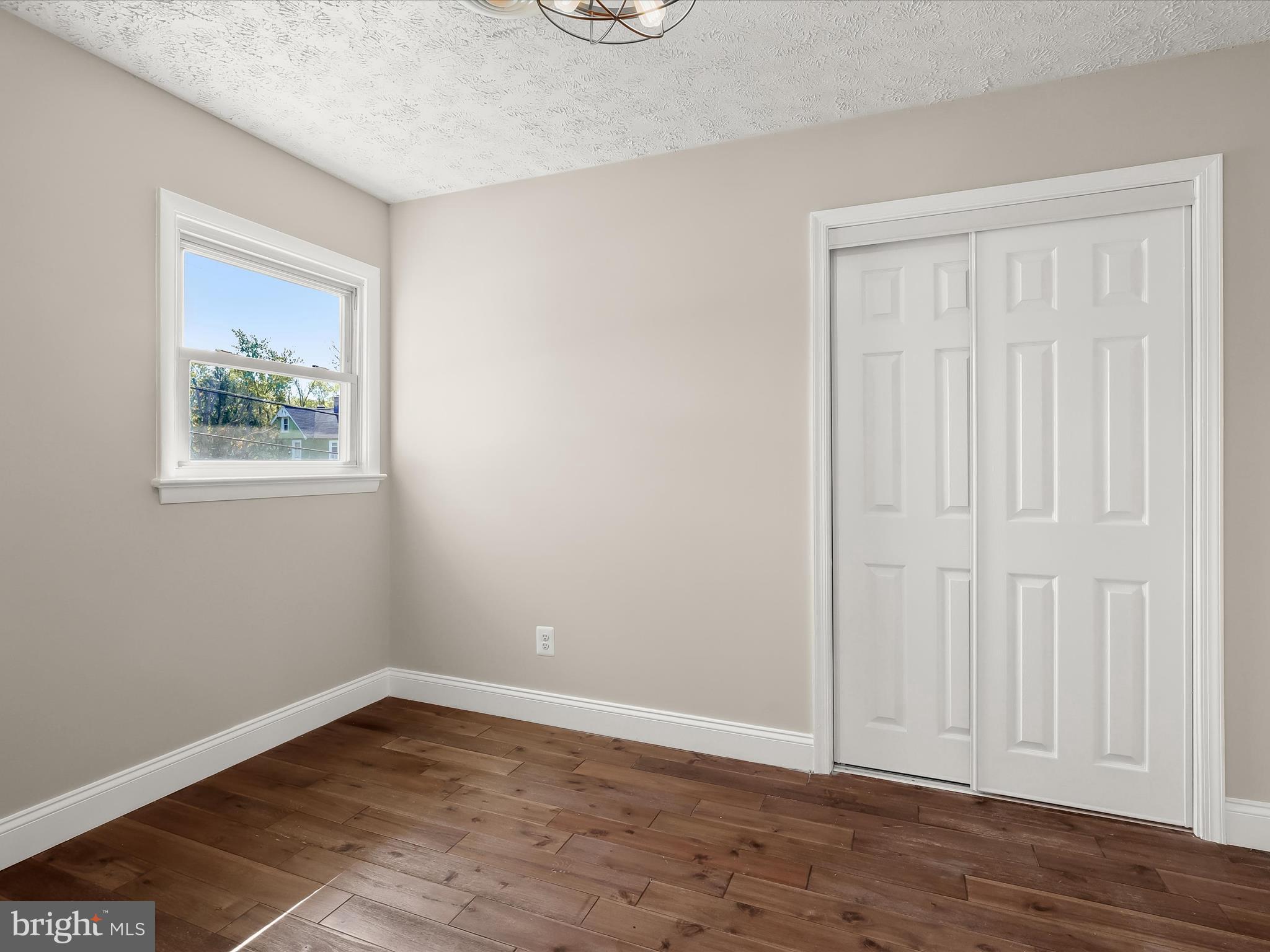1208 Joppa Road Joppa, MD 21085 - Photo 11 of 54 a view of an empty room with wooden floor and a window