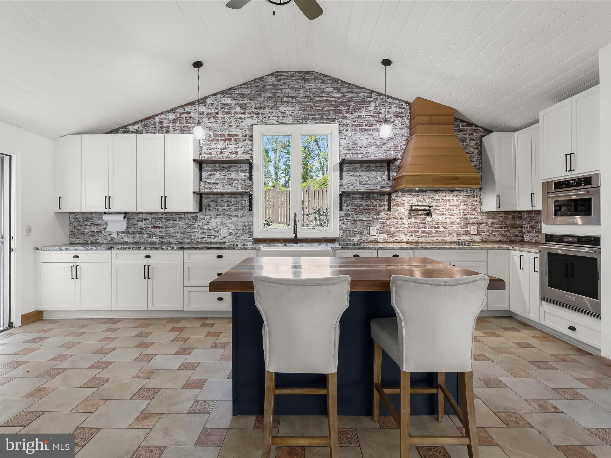 1208 Joppa Road Joppa, MD 21085 - Photo 14 of 54 a kitchen with stainless steel appliances granite countertop a stove top oven a sink a dining table and chairs