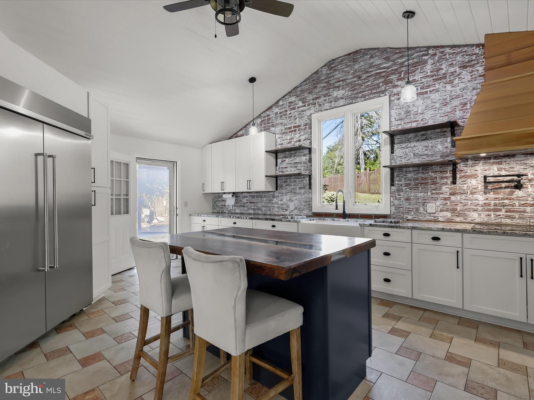 1208 Joppa Road Joppa, MD 21085 - Photo 16 of 54 a kitchen with a sink chairs and refrigerator