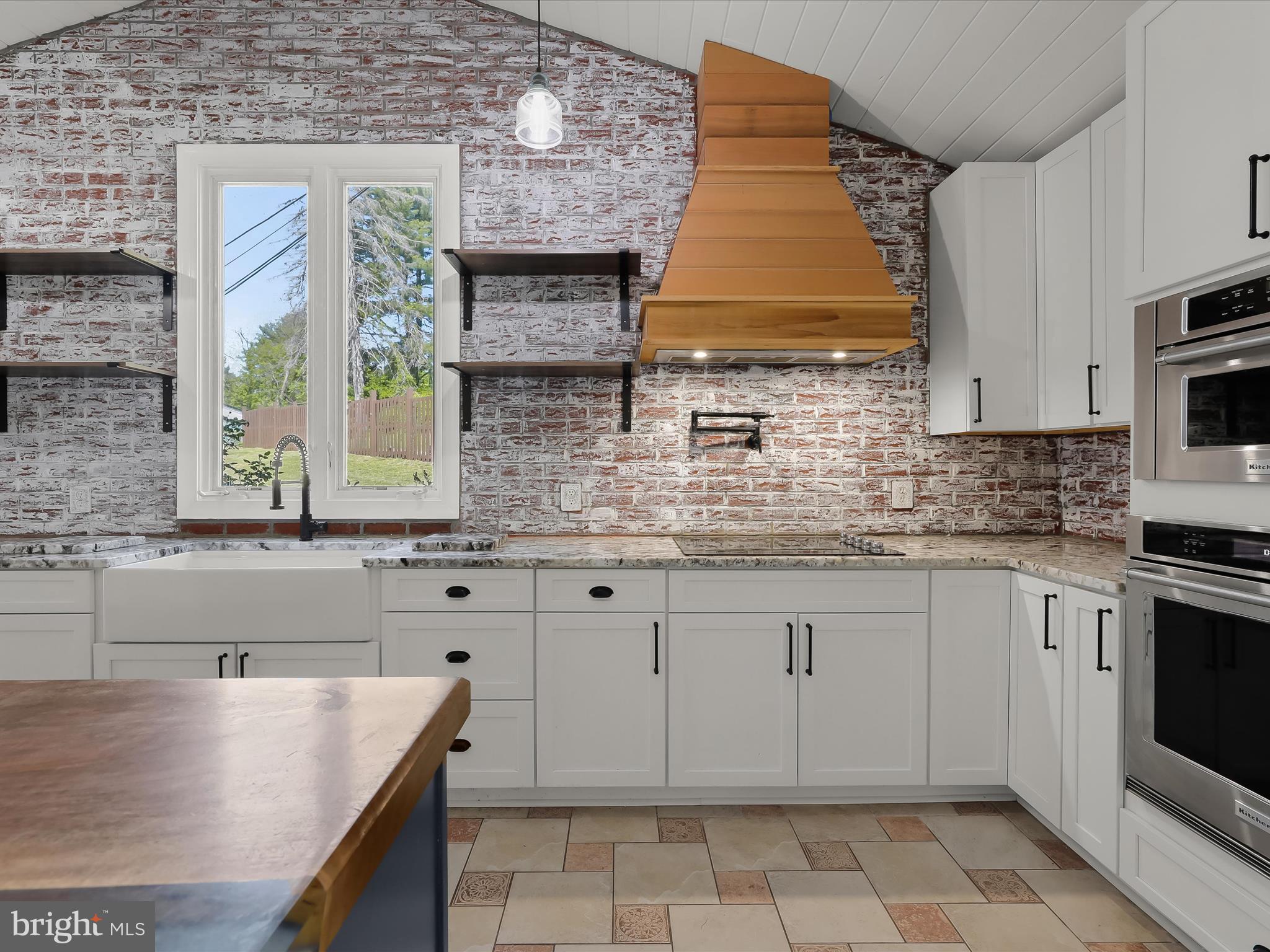 1208 Joppa Road Joppa, MD 21085 - Photo 17 of 54 a kitchen with stainless steel appliances granite countertop a stove a sink and a microwave