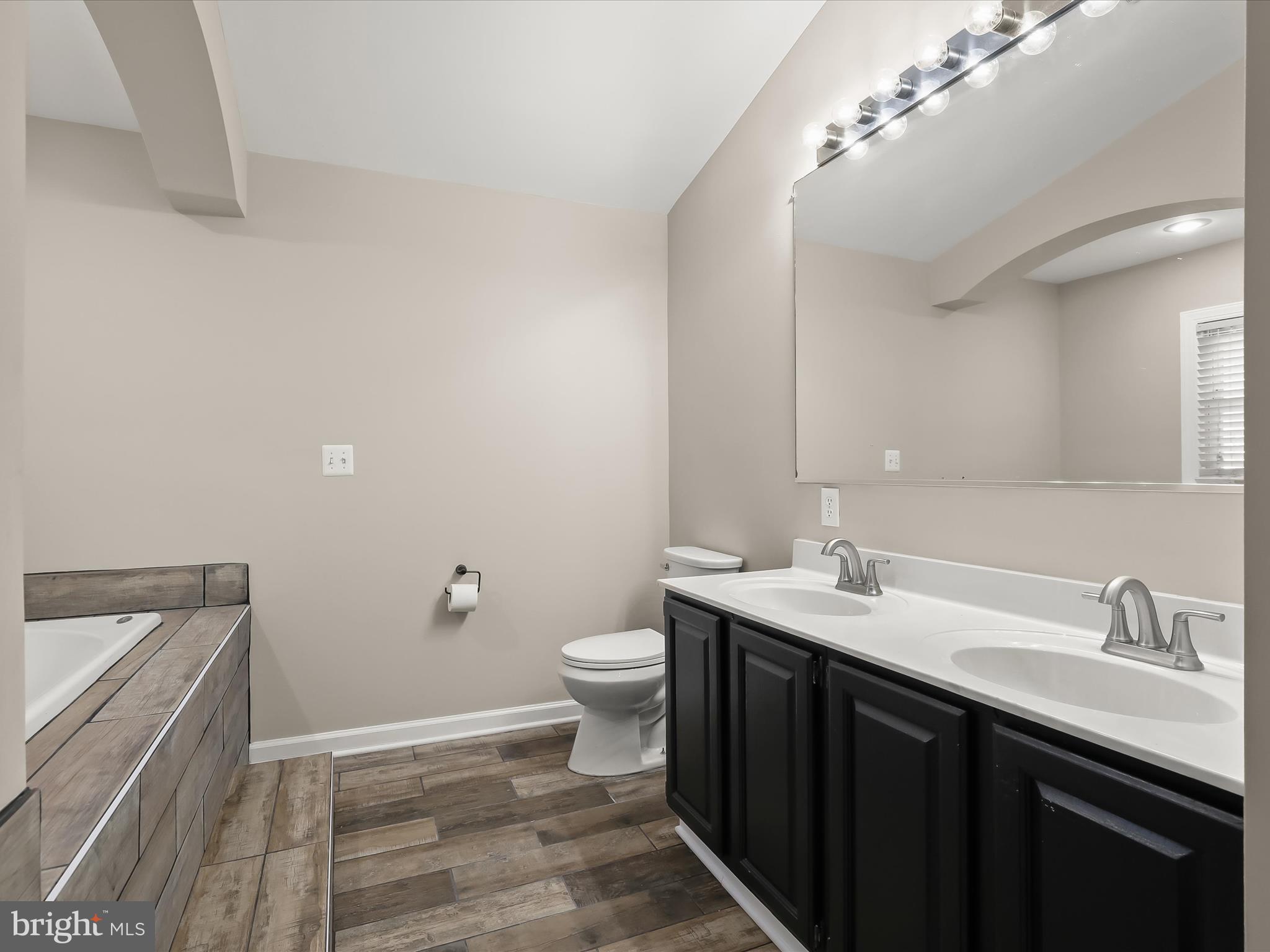 1208 Joppa Road Joppa, MD 21085 - Photo 24 of 54 a bathroom with a sink a toilet a mirror and vanity