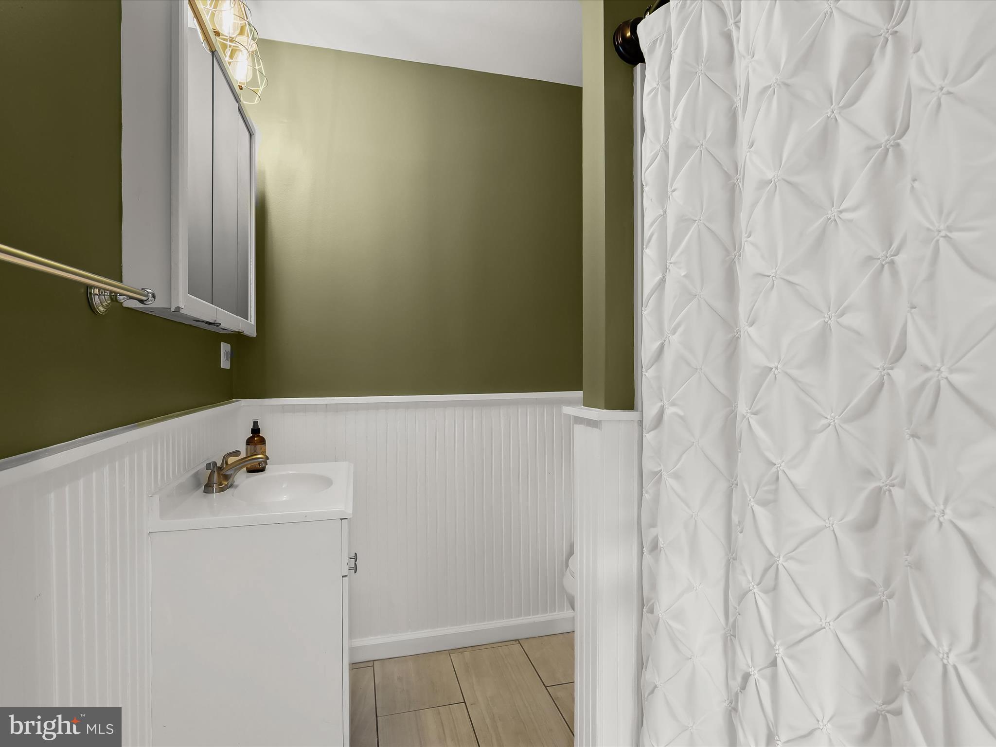 1208 Joppa Road Joppa, MD 21085 - Photo 32 of 54 a bathroom with a sink and mirror