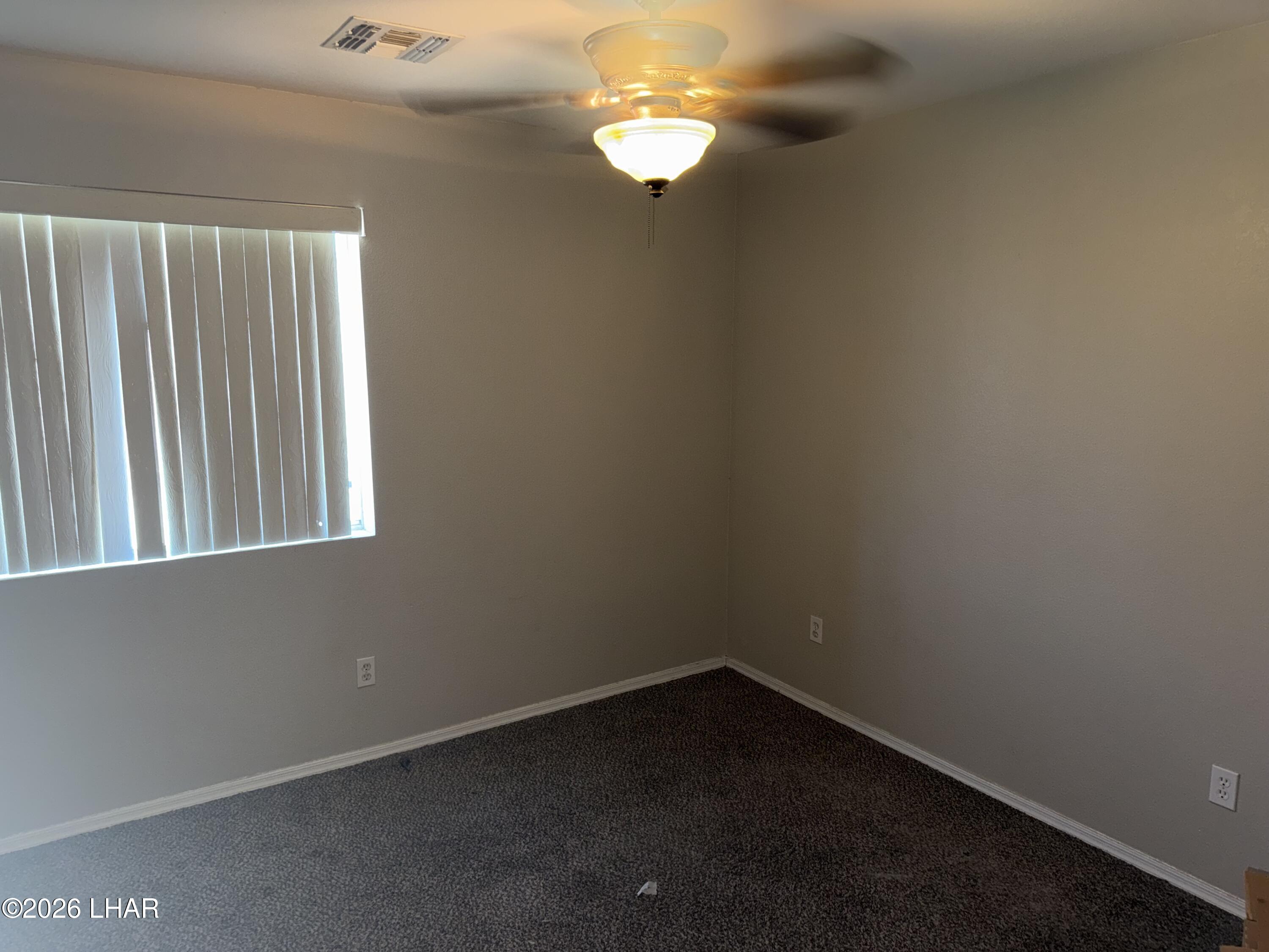 4897 South Rinaldi Drive Fort Mohave, AZ 86426 - Photo 11 of 22 a view of an empty room with a window