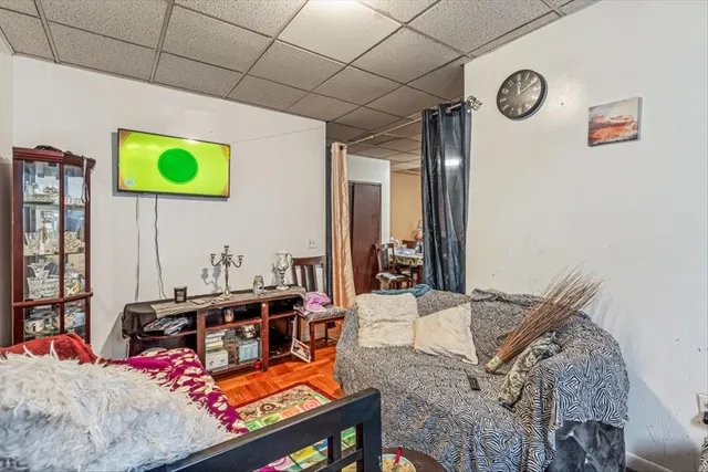a living room with a bed furniture and a window