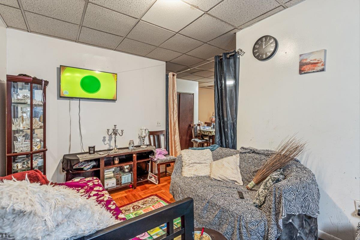 1715 St Peters Avenue Bronx, NY 10461 - Photo 11 of 30 a living room with a bed furniture and a window