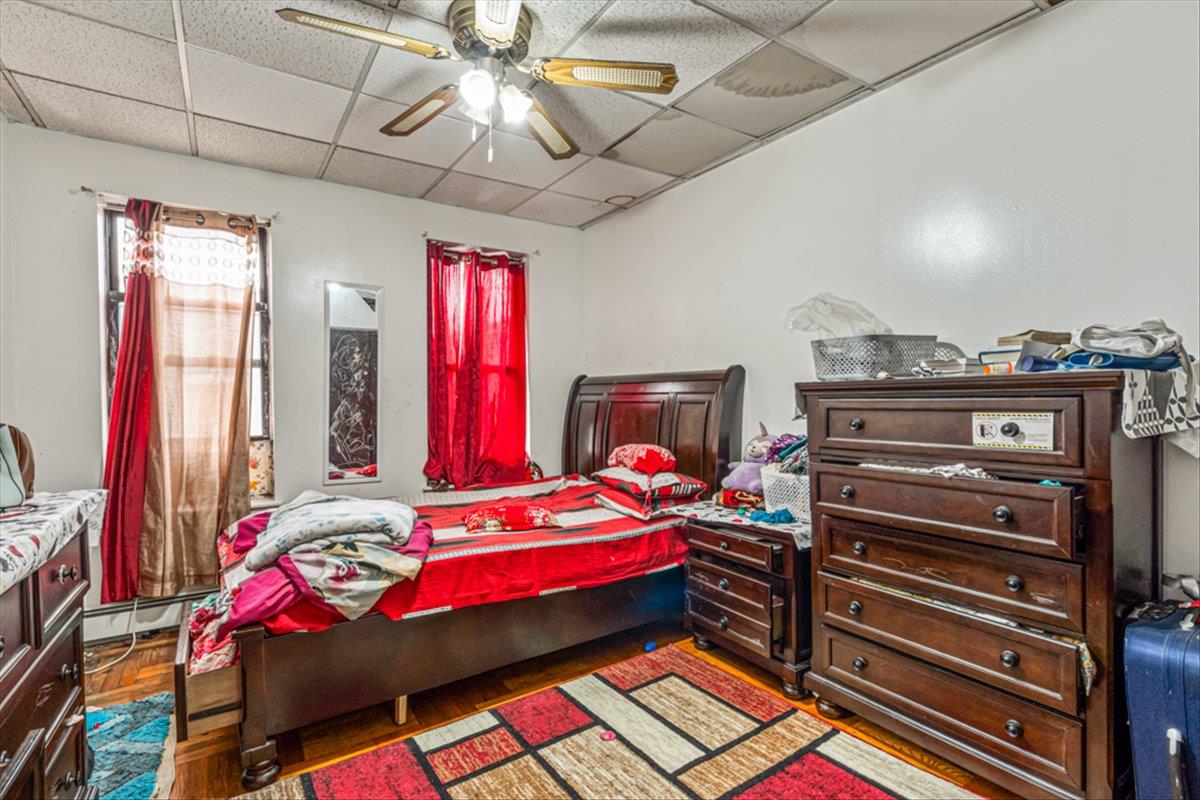 1715 St Peters Avenue Bronx, NY 10461 - Photo 12 of 30 a bedroom with a bed and a chandelier