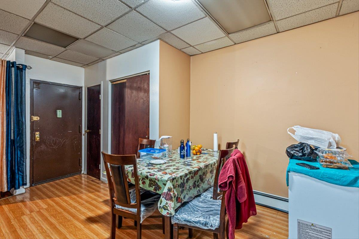 1715 St Peters Avenue Bronx, NY 10461 - Photo 17 of 30 a dining room with furniture and wooden floor
