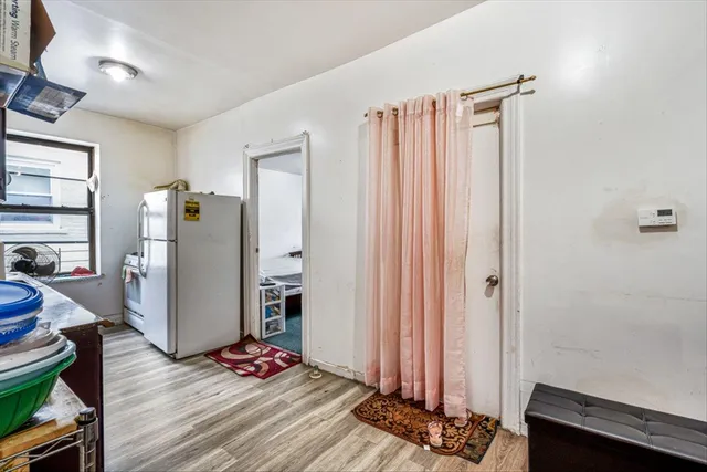 a view of room with wooden floor and windows