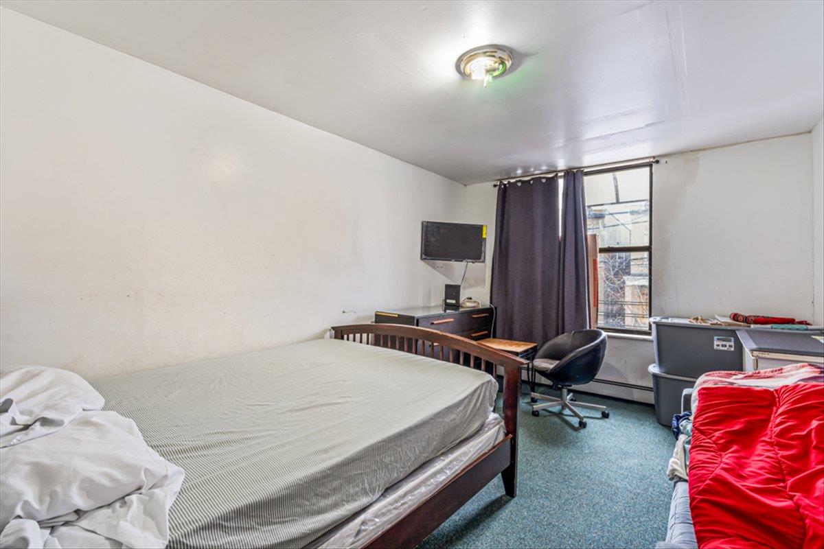 1715 St Peters Avenue Bronx, NY 10461 - Photo 6 of 30 a bedroom with a bed and a window