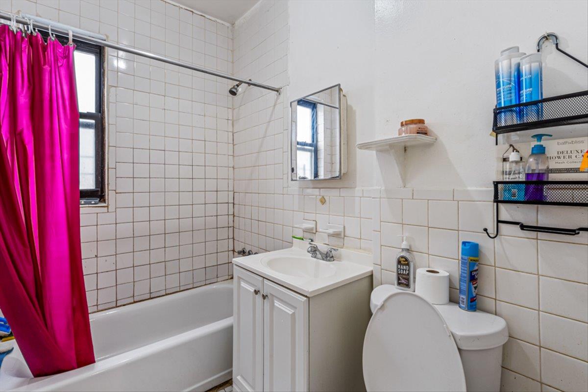 1715 St Peters Avenue Bronx, NY 10461 - Photo 8 of 30 a bathroom with a sink toilet and shower