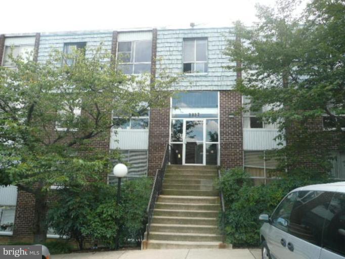 3932 Bel Pre Road, Unit 2 Silver Spring, MD 20906 - Photo 1 of 16 a front view of a house with a yard
