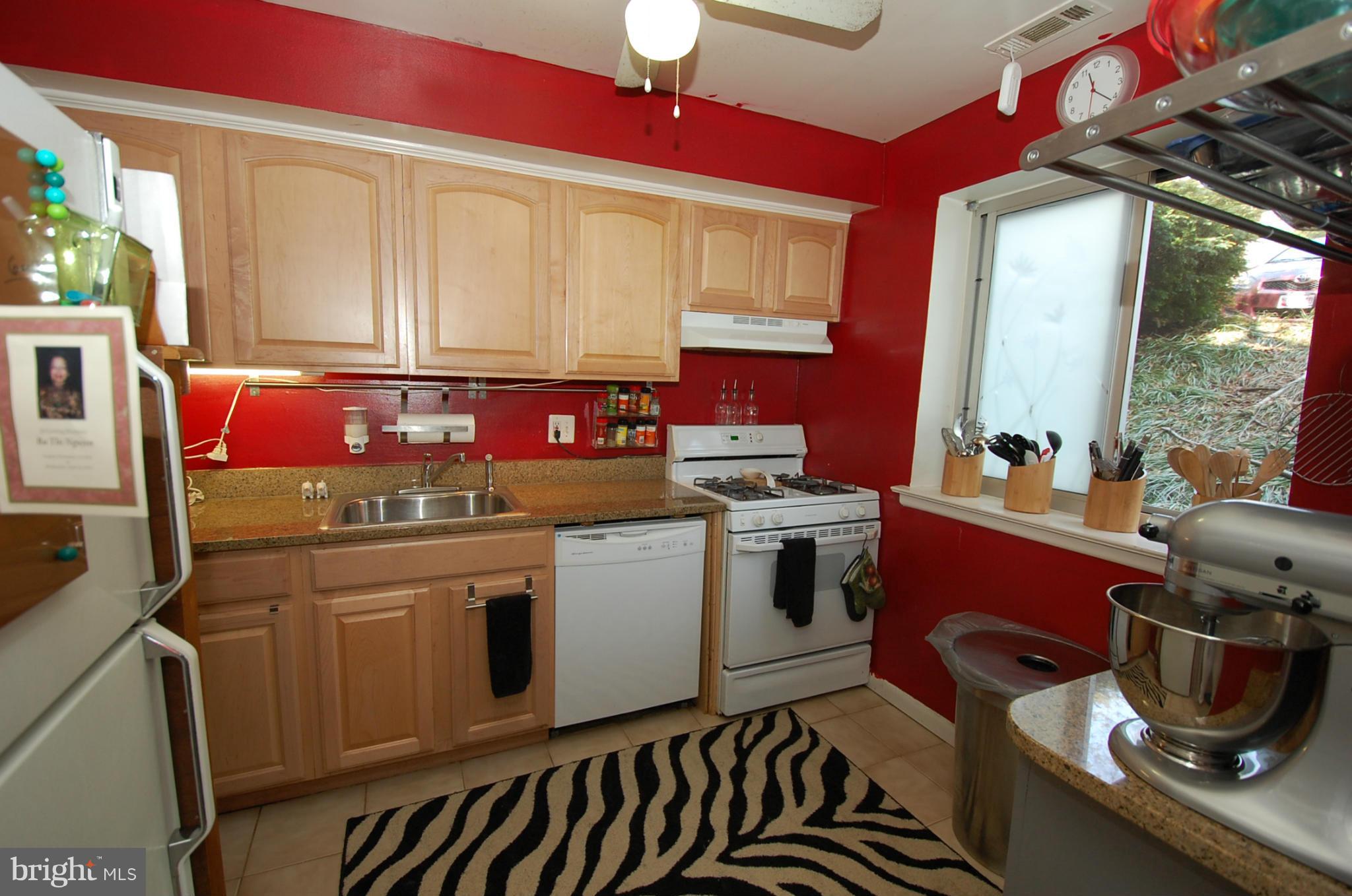 3932 Bel Pre Road, Unit 2 Silver Spring, MD 20906 - Photo 3 of 16 a kitchen with stainless steel appliances granite countertop a stove a sink dishwasher and cabinets with wooden floor