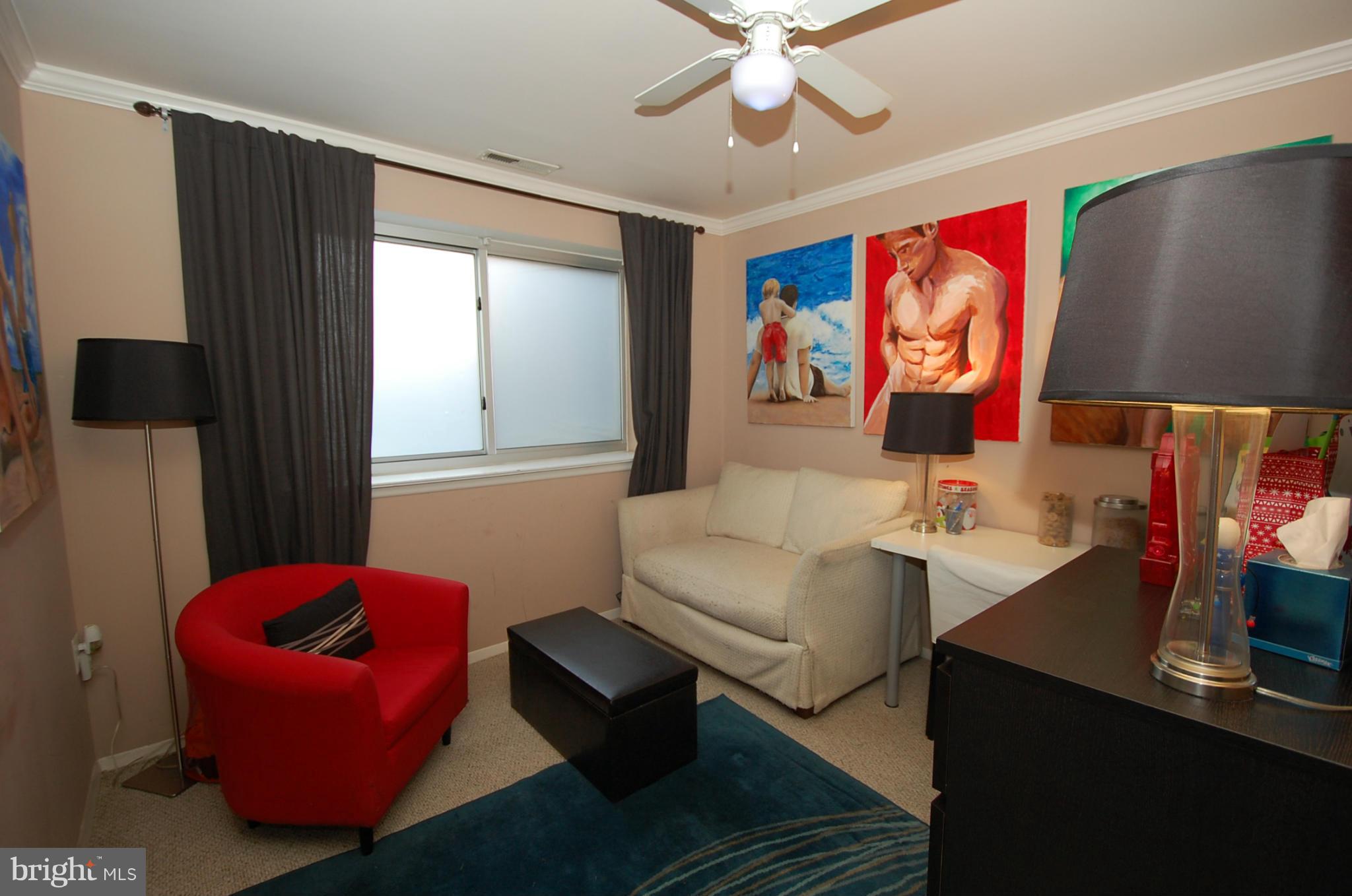 3932 Bel Pre Road, Unit 2 Silver Spring, MD 20906 - Photo 10 of 16 a living room with furniture and a flat screen tv