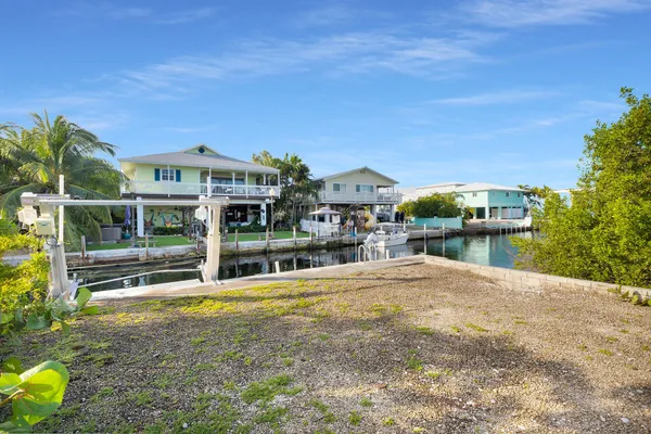 an aerial view of a house with a yard and lake view