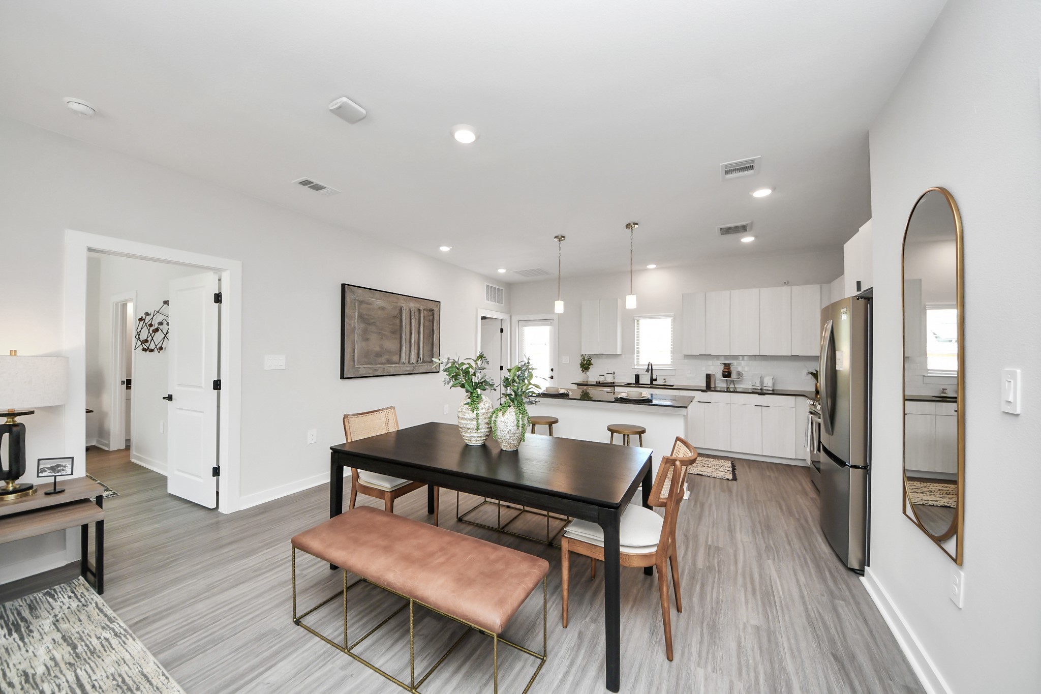 7711 Longmire Road, Unit 2 Conroe, TX 77304 - Photo 40 of 48 Boasting luxury finishes-stylish Island kitchen,granite counters,subway tile backsplash,ample custom cabinet space,stainless appliances,refrigerator,full size washer&dryer included,wood-like flooring throughout,open concept floor plan.