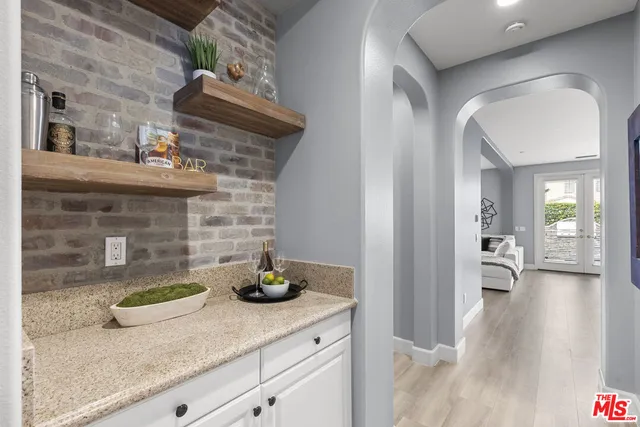 a kitchen with stainless steel appliances granite countertop a sink a stove and a refrigerator