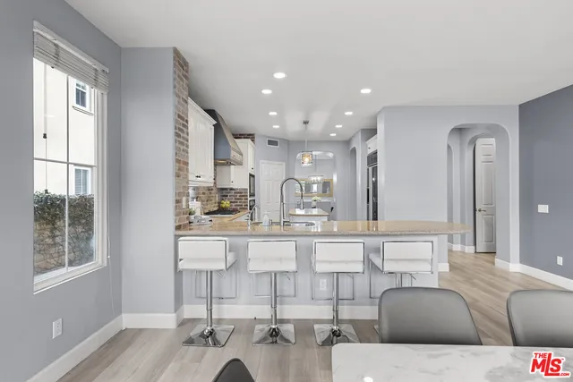 a view of a dining room with furniture a chandelier and wooden floor