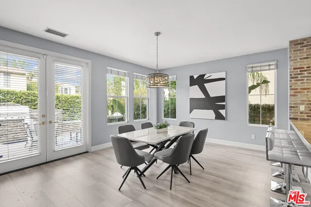 a living room with furniture a fireplace and a chandelier