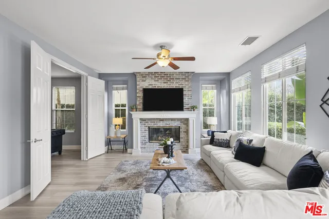 a living room with furniture a fireplace and a flat screen tv