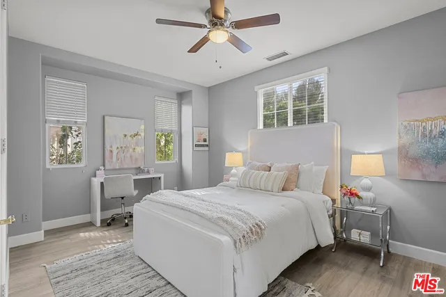 a bedroom with a large bed and a chandelier