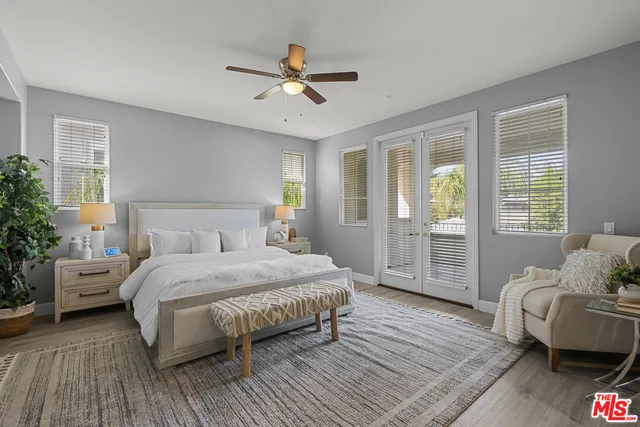 a bedroom with a bed and a potted plant
