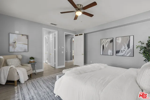 a large bathroom with a double vanity sink a toilet a mirror and shower