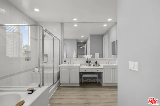 a bathroom with a tub sink and mirror