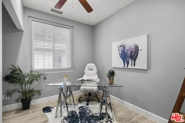 a view of a bedroom with furniture window and wooden floor