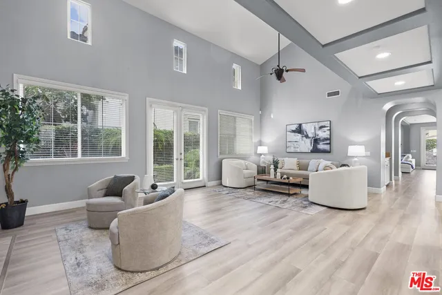 a living room with furniture and floor to ceiling windows