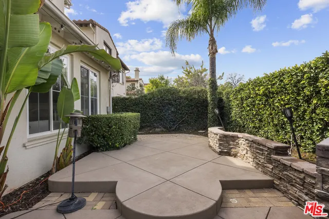 a view of a patio with a table and chairs and potted plants