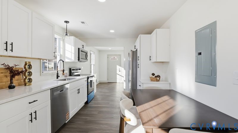 331 Walnut Street Petersburg, VA 23803 - Photo 2 of 34 a large white kitchen with lots of counter space a sink and appliances