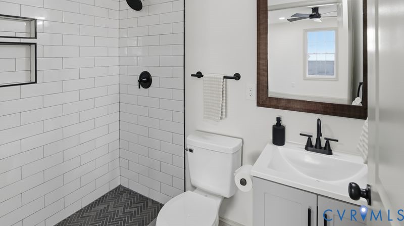331 Walnut Street Petersburg, VA 23803 - Photo 21 of 34 a bathroom with a sink a toilet and shower