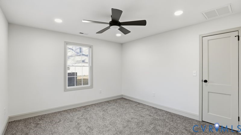 331 Walnut Street Petersburg, VA 23803 - Photo 23 of 34 an empty room with windows and ceiling fan