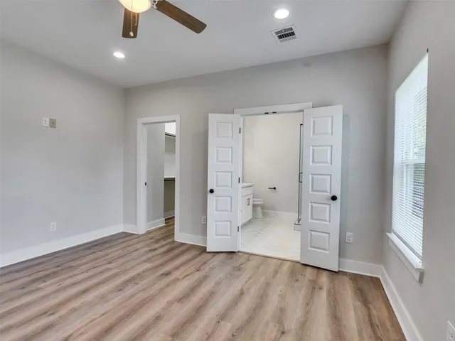 a view of a room with wooden floor and staircase