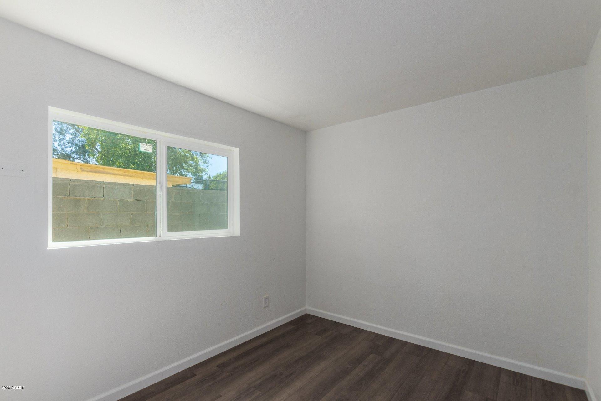 1837 West Vineyard Road Phoenix, AZ 85041 - Photo 18 of 30 an empty room with a window