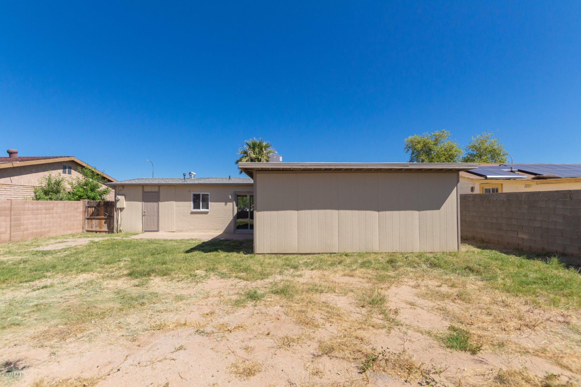 1837 West Vineyard Road Phoenix, AZ 85041 - Photo 25 of 30 a house that has a tree in front of it