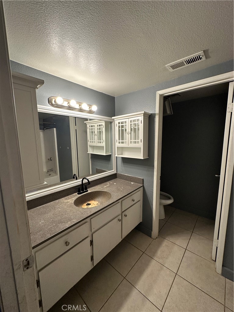 165 Racquet Club Drive Compton, CA 90220 - Photo 29 of 47 a bathroom with a double vanity sink and mirror