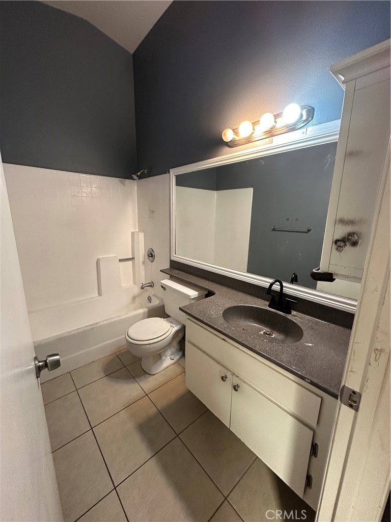 165 Racquet Club Drive Compton, CA 90220 - Photo 34 of 47 a bathroom with a granite countertop sink a toilet a mirror and vanity