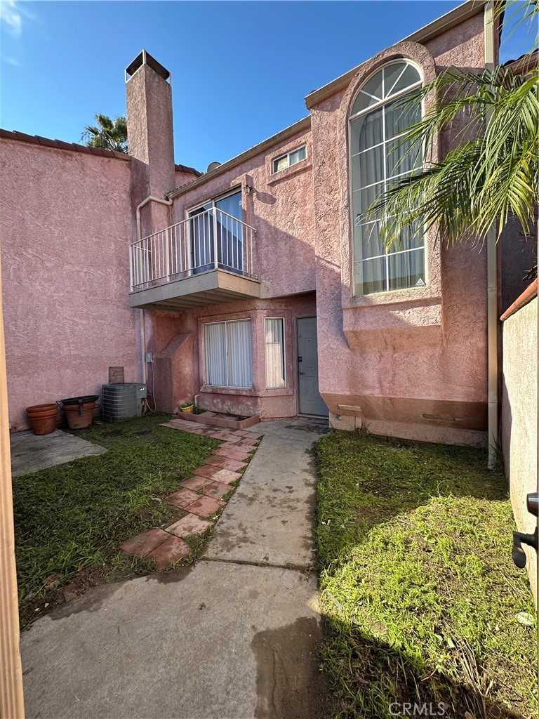 165 Racquet Club Drive Compton, CA 90220 - Photo 4 of 47 a front view of a house with a garden