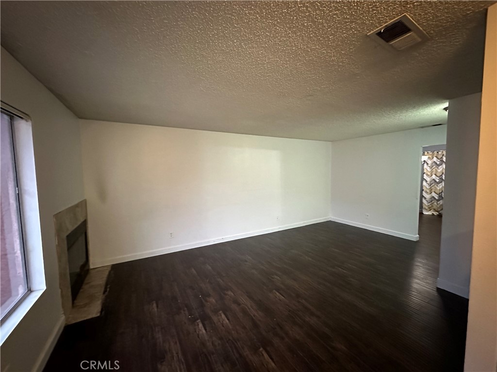 165 Racquet Club Drive Compton, CA 90220 - Photo 6 of 47 a view of an empty room with wooden floor and a window