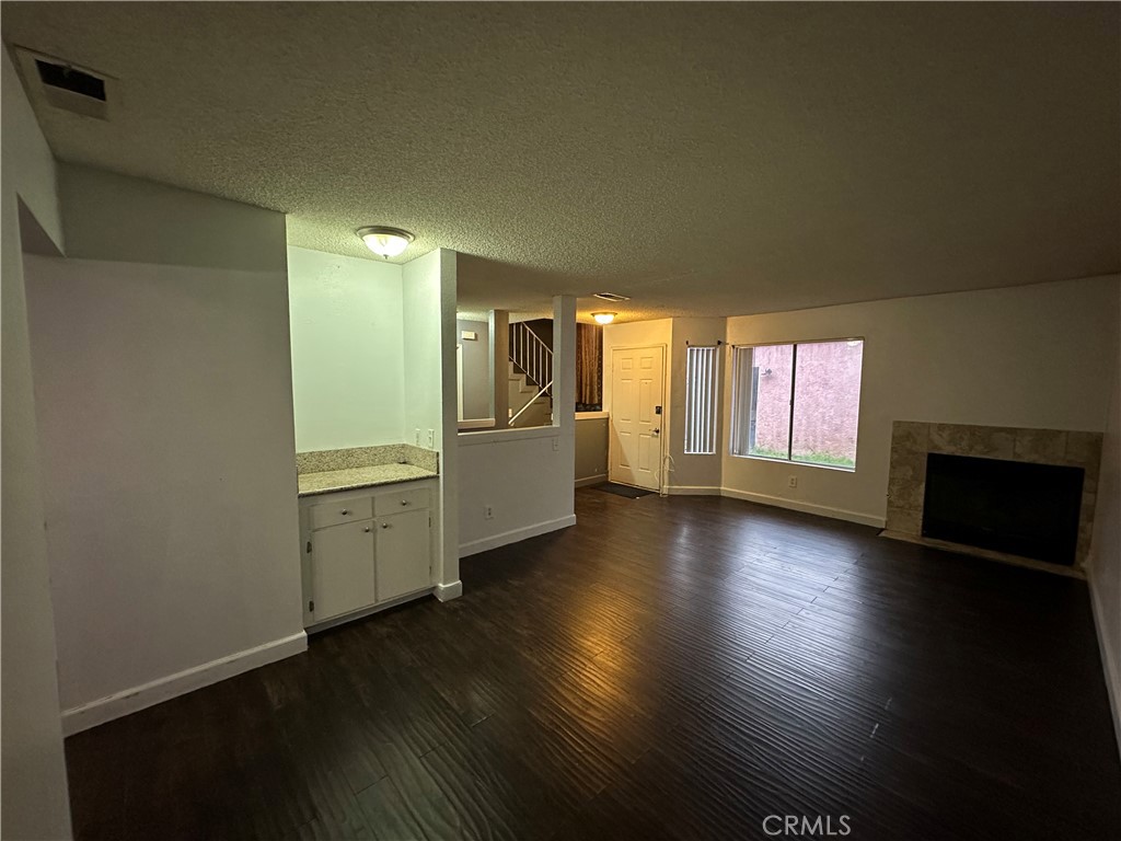 165 Racquet Club Drive Compton, CA 90220 - Photo 8 of 47 wooden floor in an empty room with a window