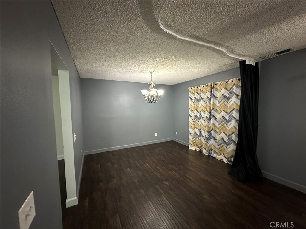 165 Racquet Club Drive Compton, CA 90220 - Photo 9 of 47 an empty room with wooden floor and windows