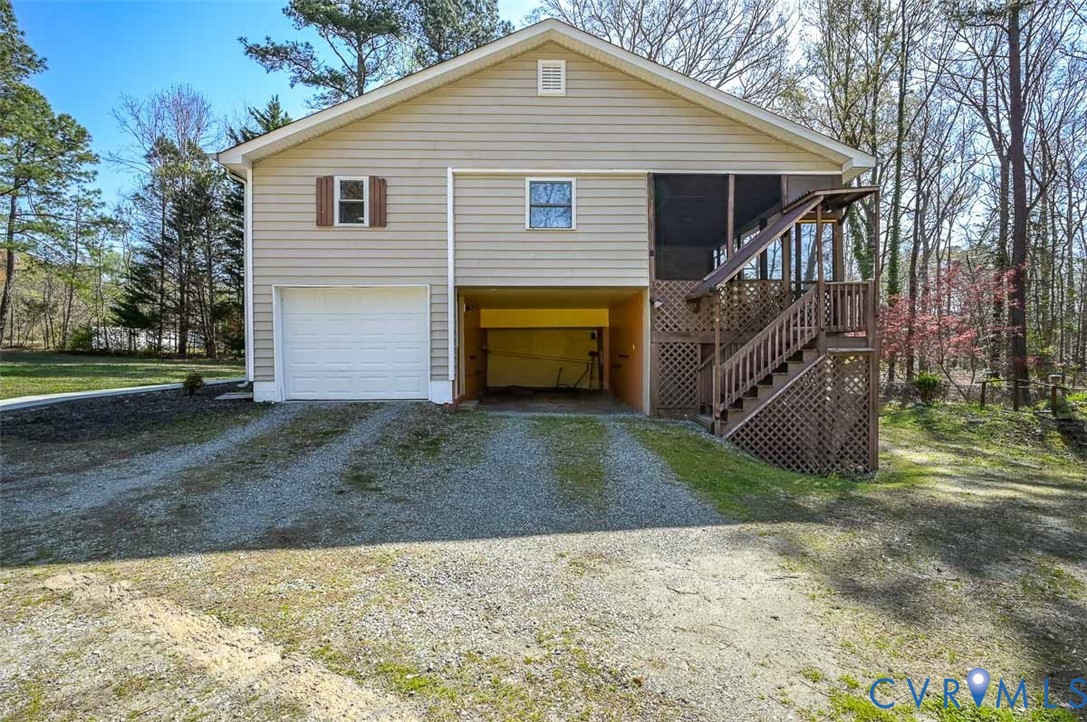 13124 Old Happy Hill Road Chester, VA 23831 - Photo 4 of 64 a front view of a house with a yard and garage