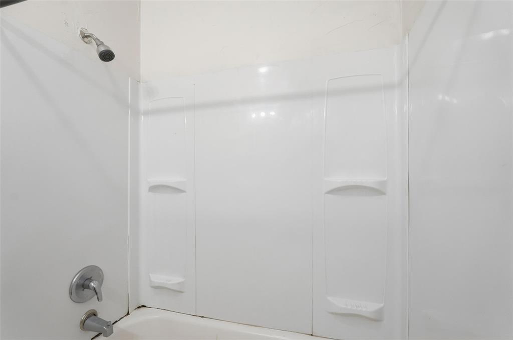 900 West Morgan Street Denison, TX 75020 - Photo 15 of 40 a bathroom with a shower